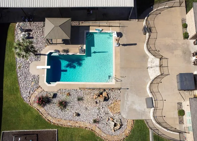 an aerial view of a house with garden space and patio