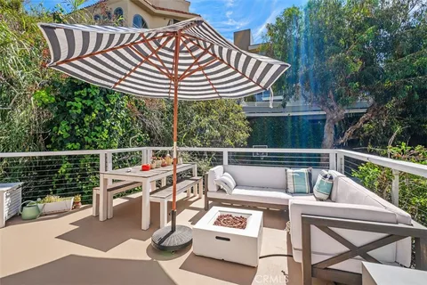 a view of a patio with a table chairs and a wooden deck
