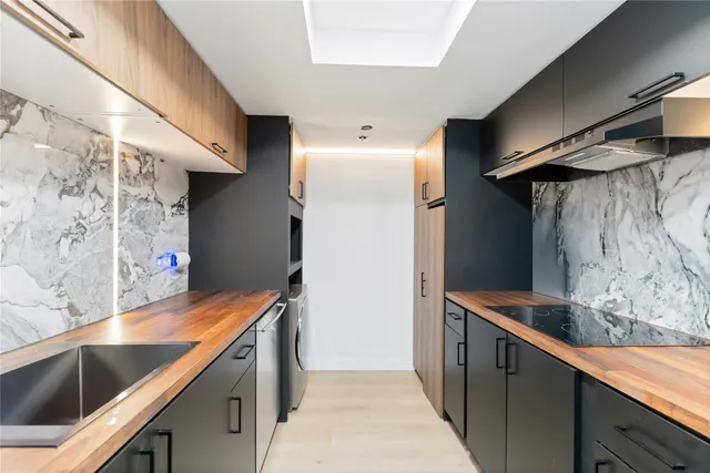 a kitchen with stainless steel appliances granite countertop a sink and a stove