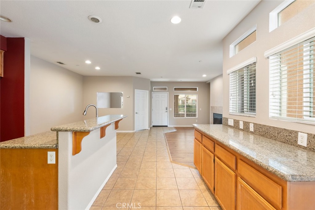 6228 Manzanita Way Riverside, CA 92504 - Photo 11 of 42 a large kitchen with stainless steel appliances a large window and a sink