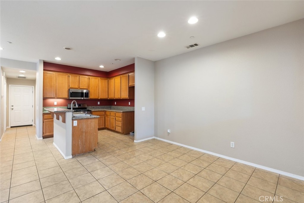 6228 Manzanita Way Riverside, CA 92504 - Photo 12 of 42 a kitchen with stainless steel appliances a refrigerator and a stove top oven