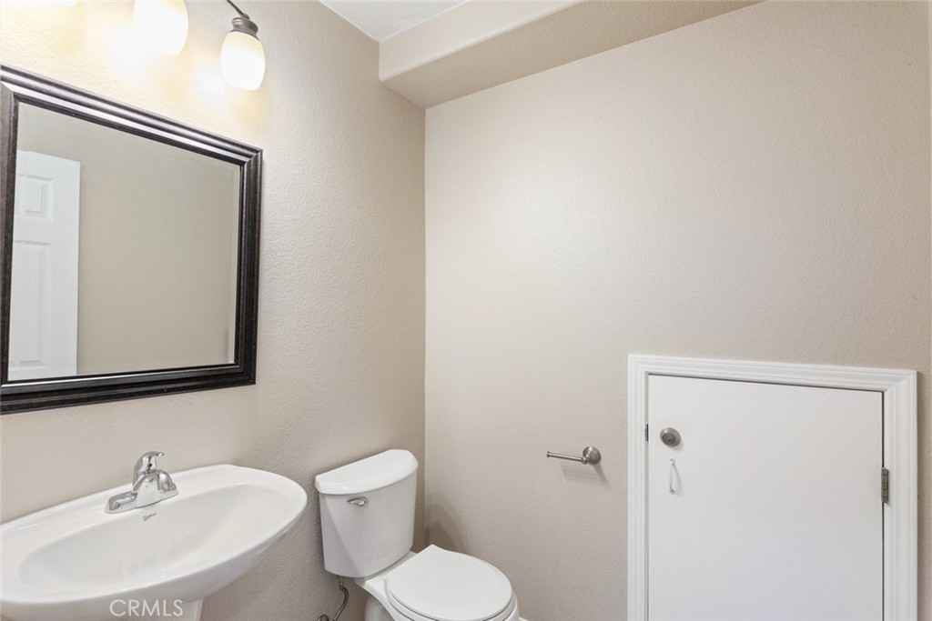 6228 Manzanita Way Riverside, CA 92504 - Photo 13 of 42 a bathroom with a toilet a sink and mirror