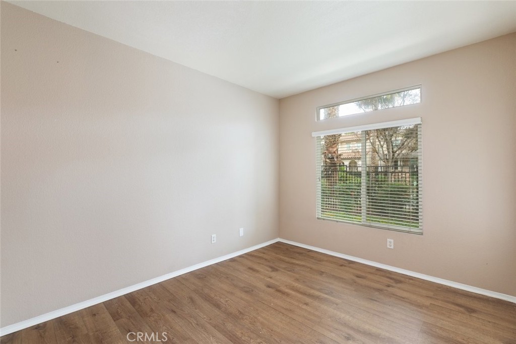 6228 Manzanita Way Riverside, CA 92504 - Photo 27 of 42 a view of an empty room with wooden floor and a window