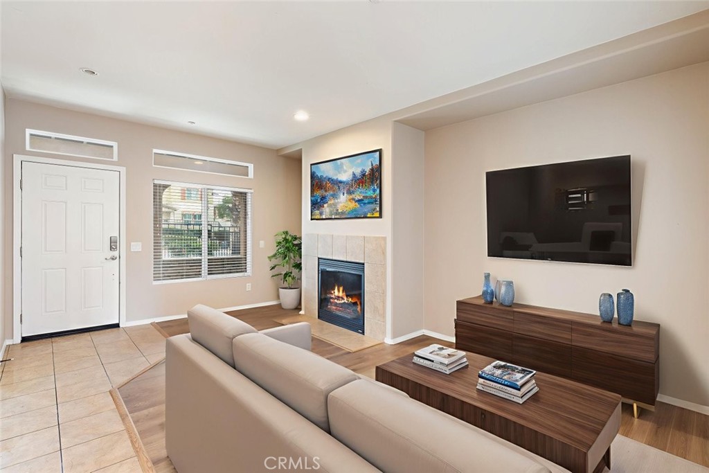 6228 Manzanita Way Riverside, CA 92504 - Photo 6 of 42 a living room with furniture a fireplace and a flat screen tv