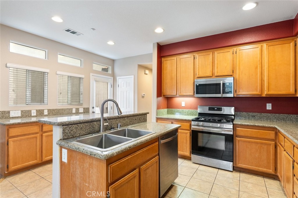 6228 Manzanita Way Riverside, CA 92504 - Photo 8 of 42 a kitchen that has a sink and a stove in it