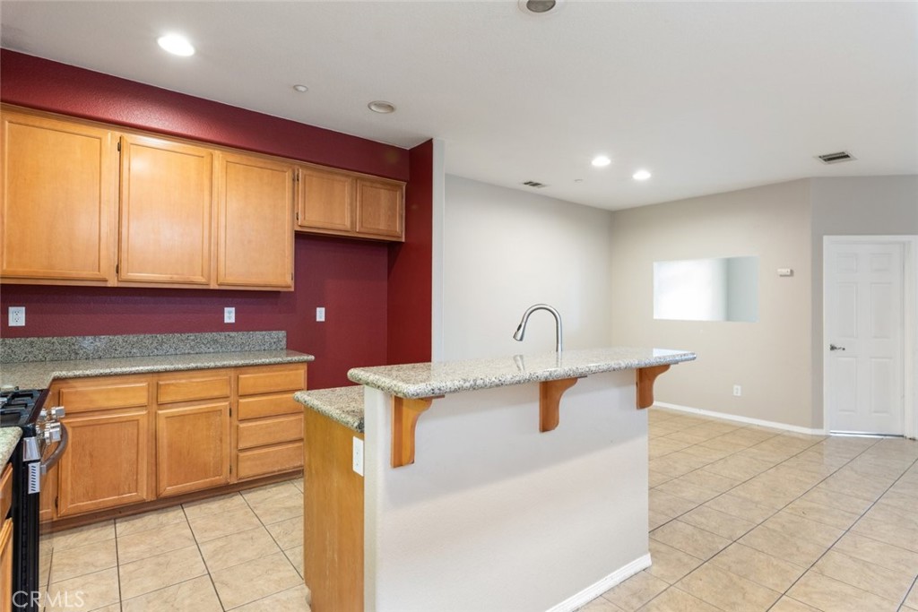 6228 Manzanita Way Riverside, CA 92504 - Photo 10 of 42 a kitchen with stainless steel appliances granite countertop a sink and a stove