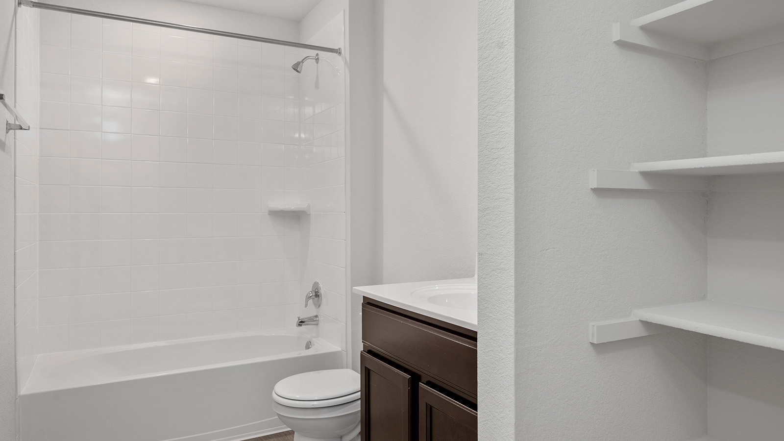 1417 Victory Rnch Trail Killeen, TX 76549 - Photo 18 of 22 A well-appointed bath features a tub, shower, and convenient storage shelving.