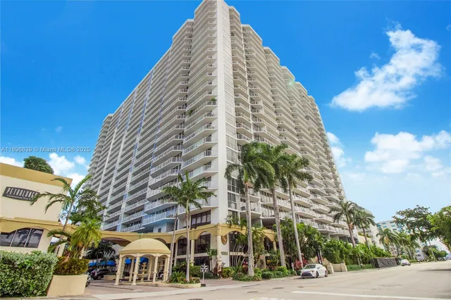 a view of a tall building next to a road