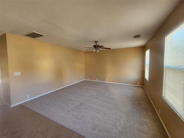 an empty room with a empty space and a window