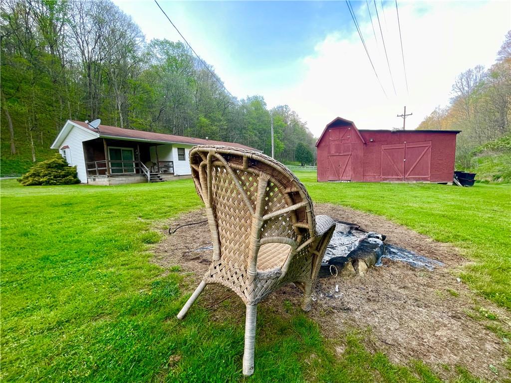 474 Iron Rock Road Waynesburg, PA 15370 - Photo 4 of 15 a view of a backyard with table and chairs a barbeque
