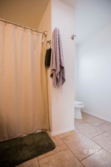 1609 South McCall Street Ridgecrest, CA 93555 - Photo 22 of 33 a bathroom with a shower and a toilet