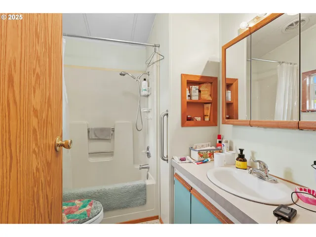 a bathroom with a sink a mirror and a shower