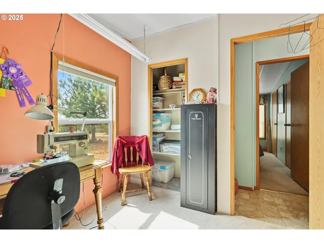 a living room with furniture a window and a flat screen tv