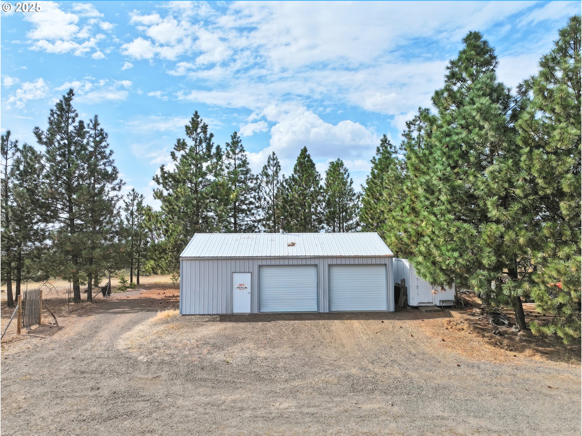 44 Pumphouse Road Goldendale, WA 98620 - Photo 27 of 35 a view of a white house with a yard and large trees