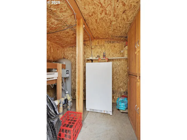 a picture of a room with a door open and a microwave