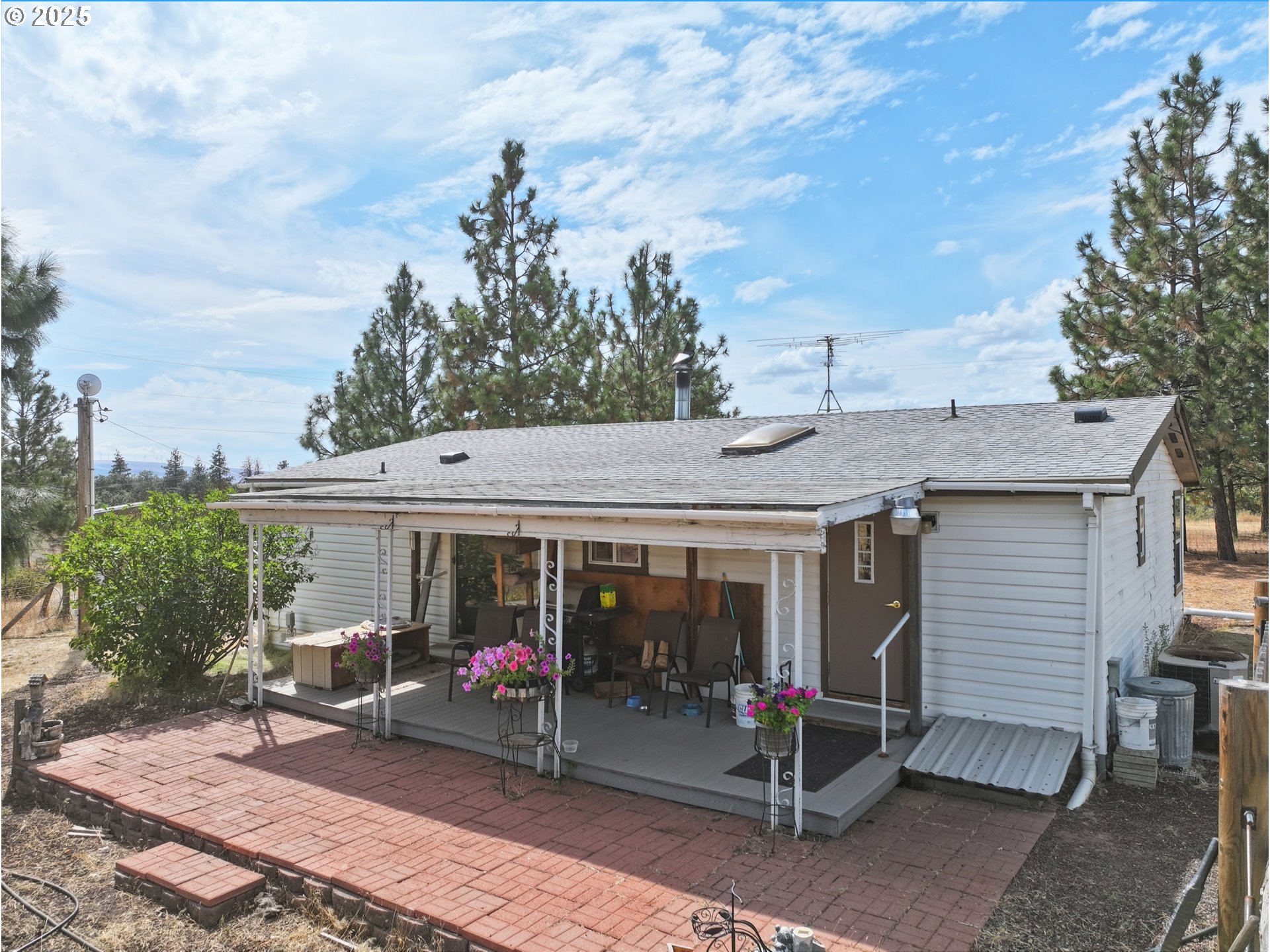 44 Pumphouse Road Goldendale, WA 98620 - Photo 5 of 35 a view of a patio with table and chairs and floor to ceiling window