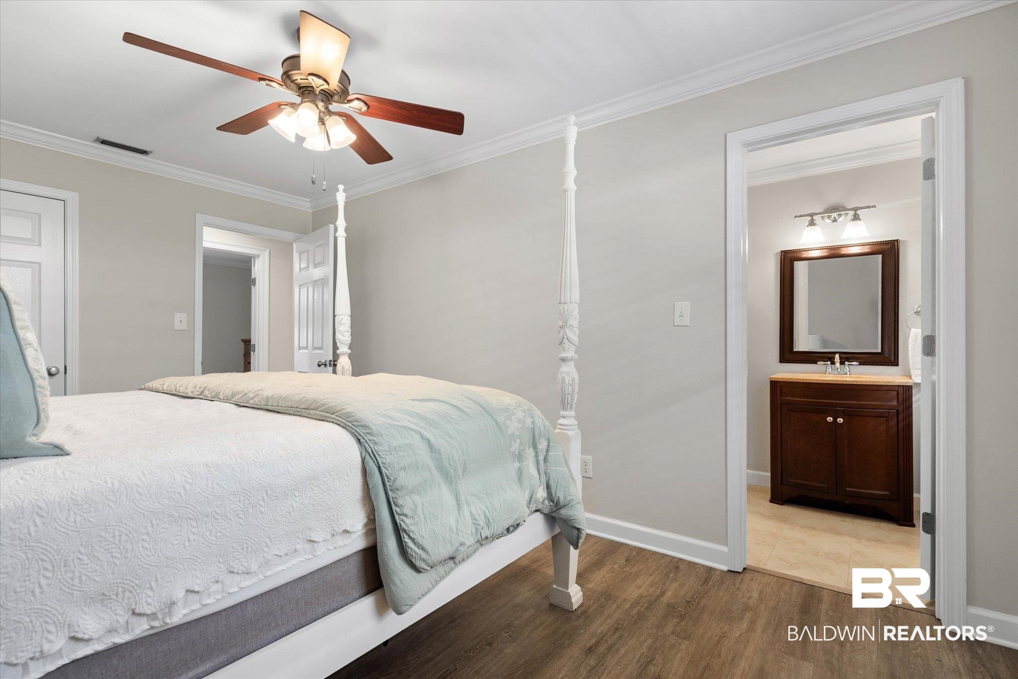 3715 Latigo Road Mobile, AL 36695 - Photo 16 of 39 Bedroom with wood finished floors, crown molding, baseboards, a sink, and ensuite bath