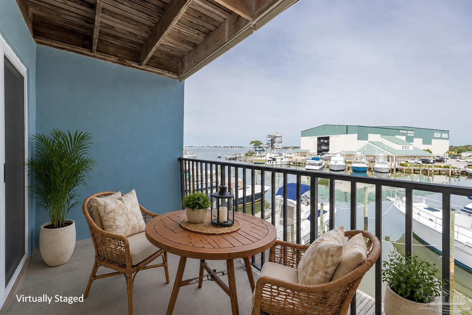 14100 River Road, Unit 228B Pensacola, FL 32507 - Photo 30 of 41 a balcony with a table and chairs