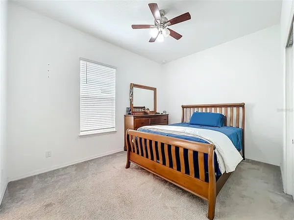 a bedroom with a bed and a cabinet