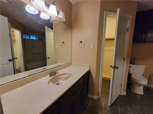 a bathroom with a sink a toilet and a mirror