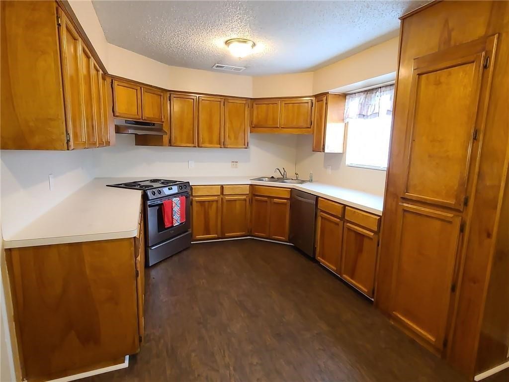 5201 Snowgoose Road Corpus Christi, TX 78413 - Photo 7 of 21 a kitchen with stainless steel appliances granite countertop sink refrigerator and microwave