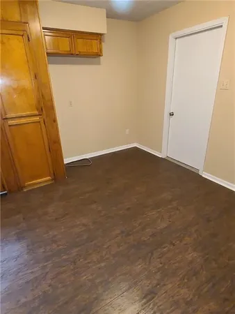 an empty room with wooden floor