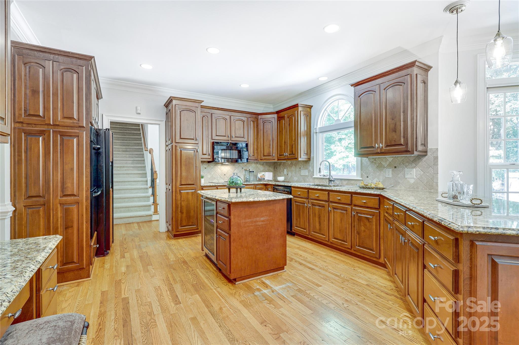 2500 High Ridge Road Charlotte, NC 28270 - Photo 14 of 47 a kitchen with stainless steel appliances granite countertop a refrigerator a sink dishwasher a stove with wooden cabinets and floor