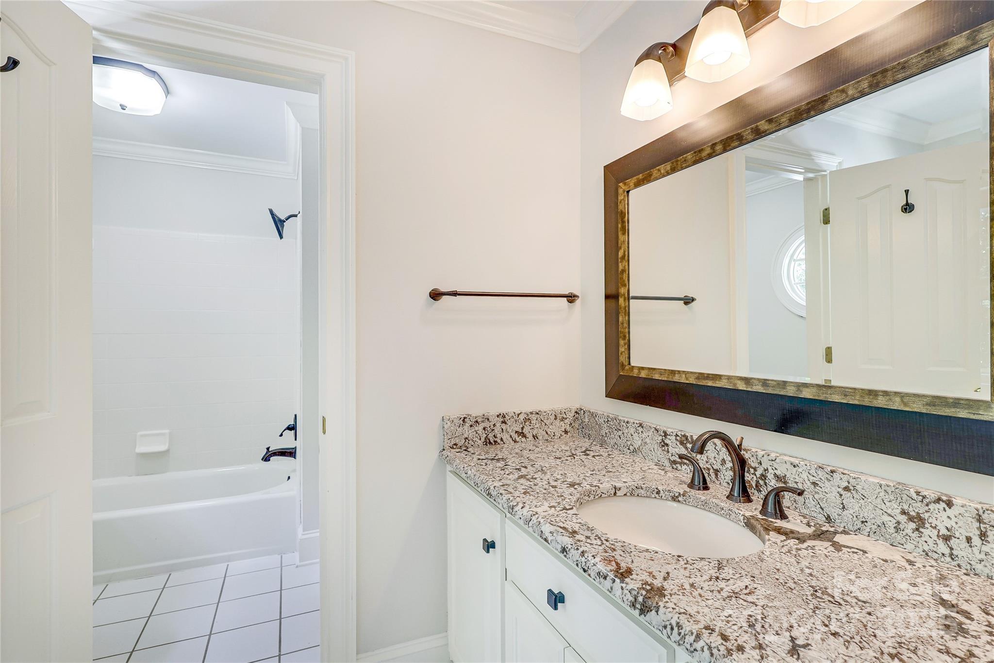 2500 High Ridge Road Charlotte, NC 28270 - Photo 38 of 47 a bathroom with a granite countertop sink a mirror and a bathtub