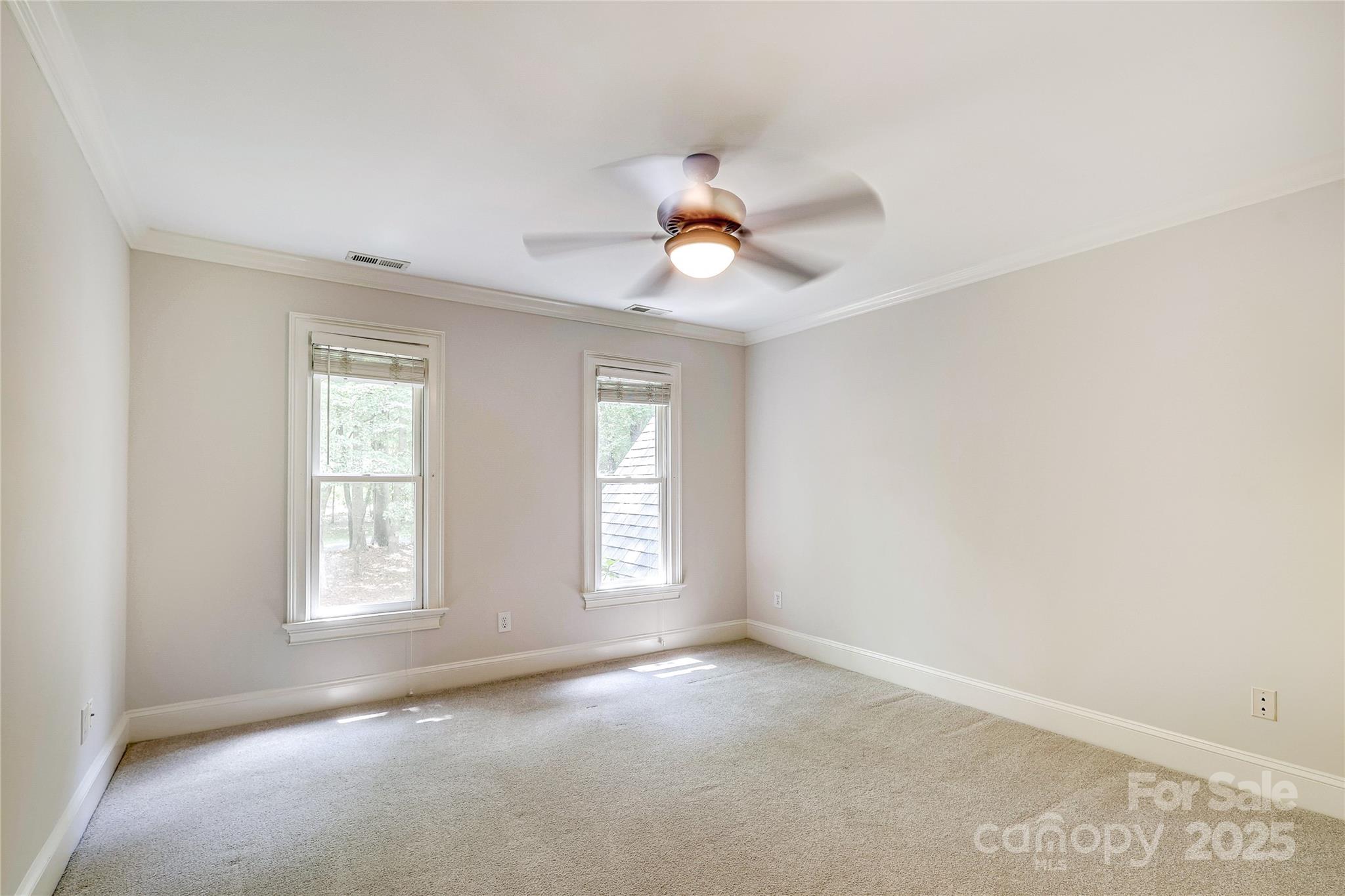 2500 High Ridge Road Charlotte, NC 28270 - Photo 40 of 47 an empty room with windows and chandelier fan