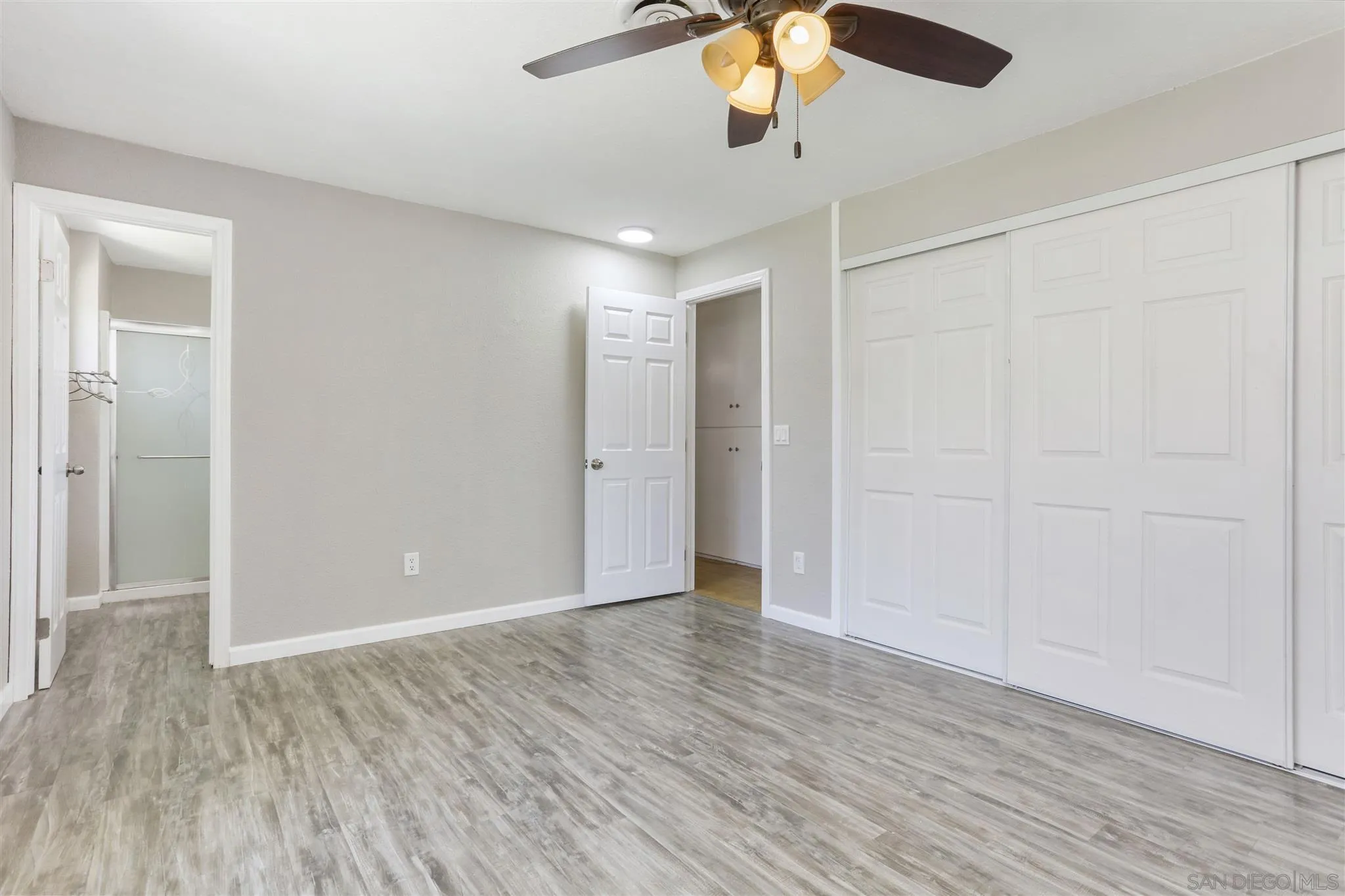 13726 Utopia Road Poway, CA 92064 - Photo 11 of 19 an empty room with wooden floor fan and windows