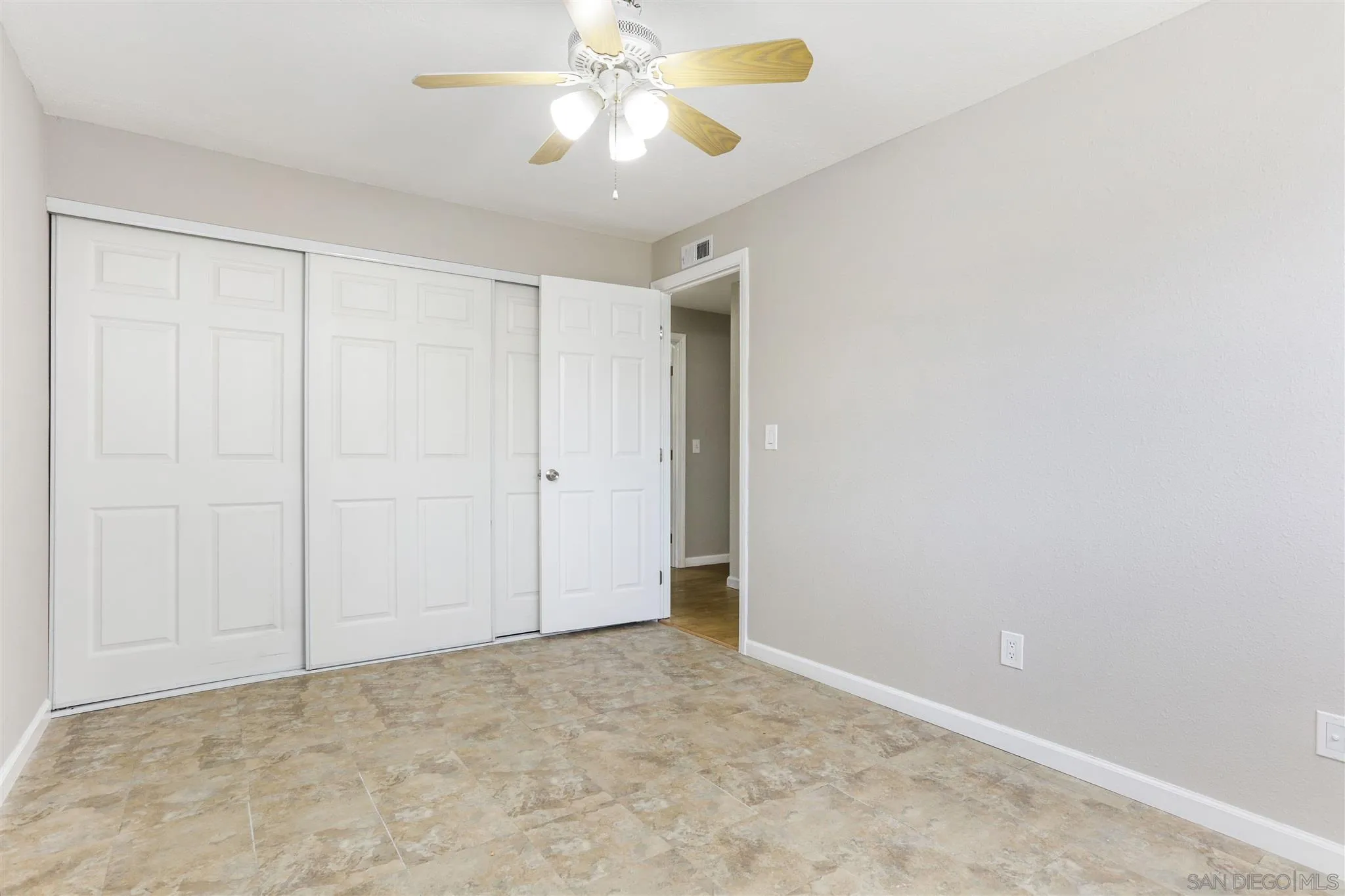 13726 Utopia Road Poway, CA 92064 - Photo 13 of 19 an empty room with a chandelier fan and closet