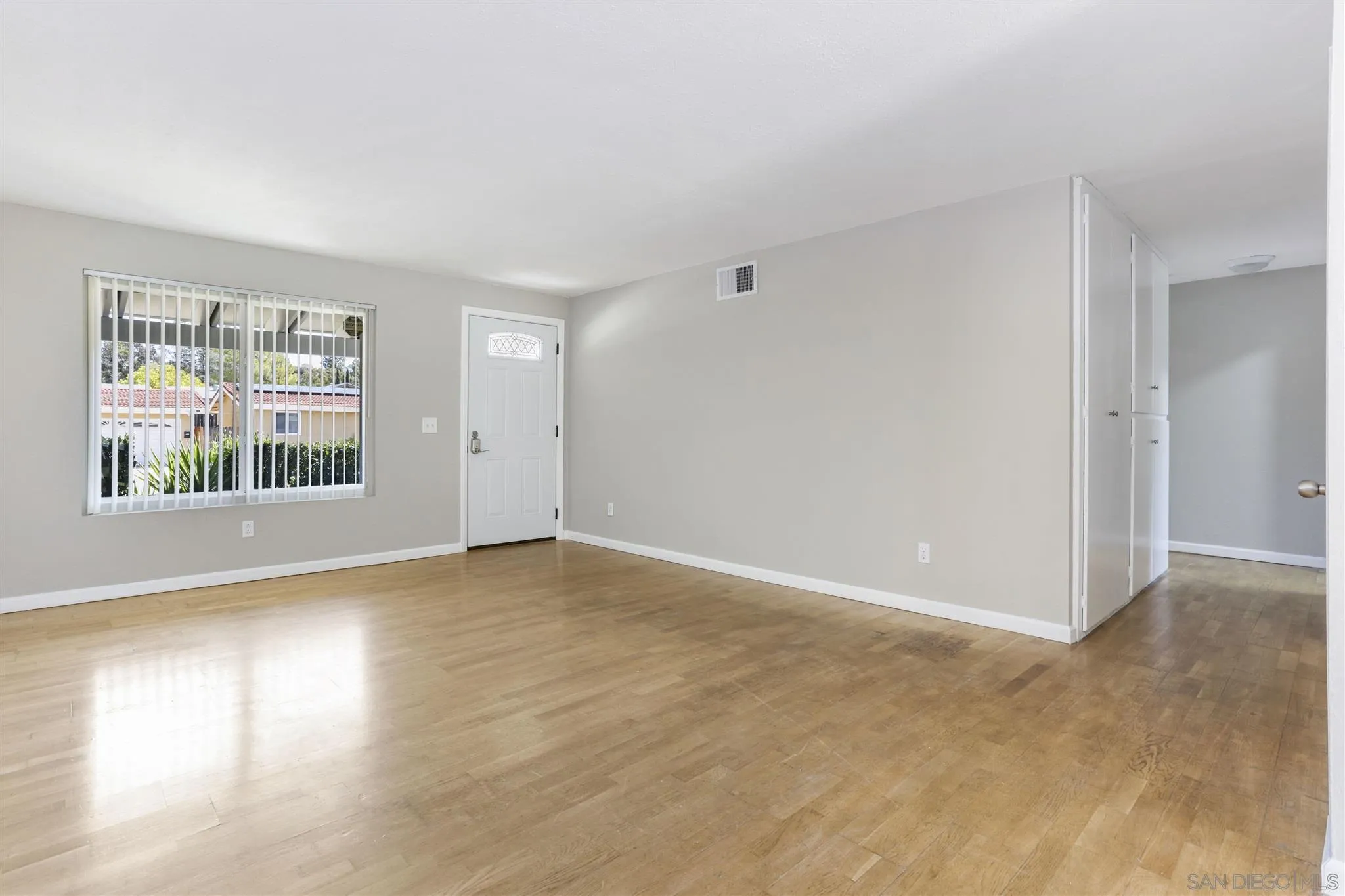 13726 Utopia Road Poway, CA 92064 - Photo 4 of 19 a view of an empty room with a window and wooden floor