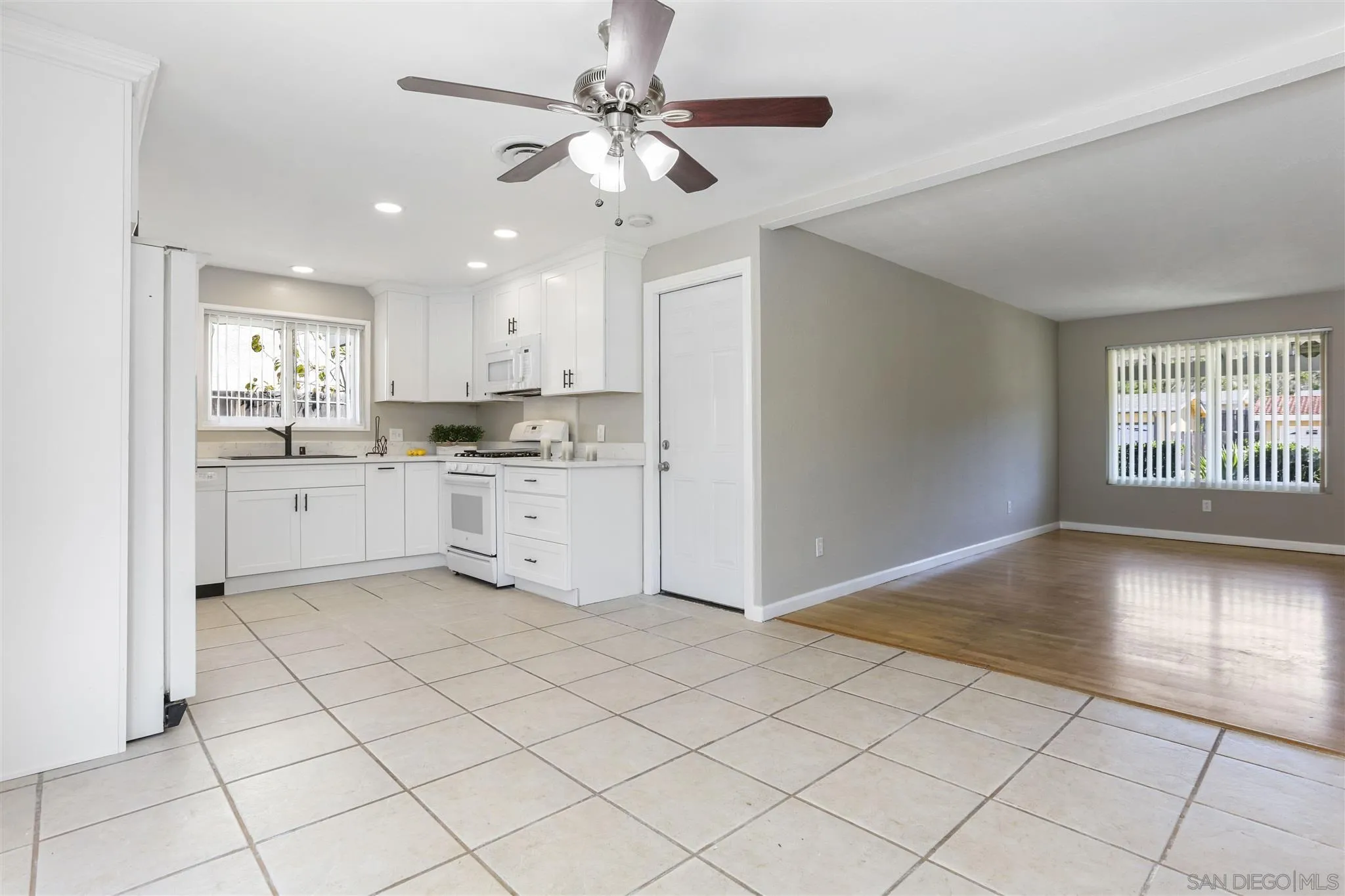 13726 Utopia Road Poway, CA 92064 - Photo 6 of 19 a view of a kitchen with white cabinets appliances and a window