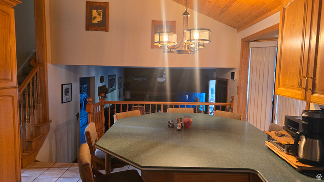 11077 Susan Drive Sandy, UT 84092 - Photo 11 of 20 Dining room featuring stairway, lofted ceiling, wooden ceiling, light tile patterned floors, and a chandelier