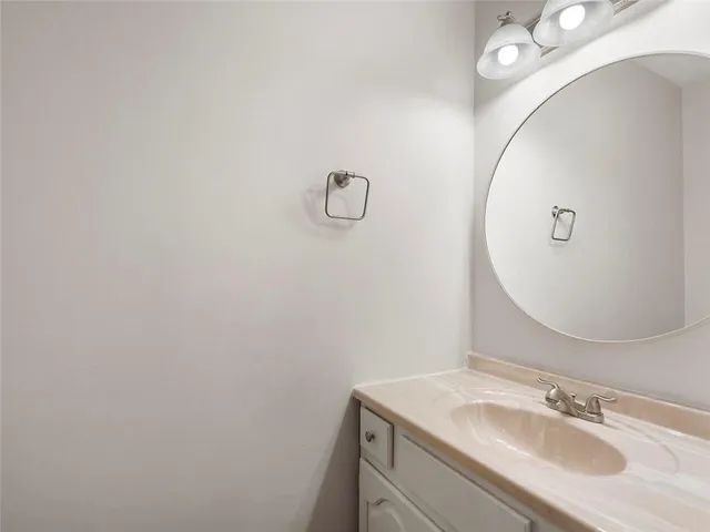a bathroom with a sink vanity and a mirror