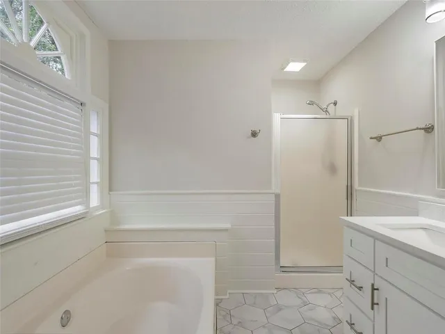 a bathroom with a shower and a sink