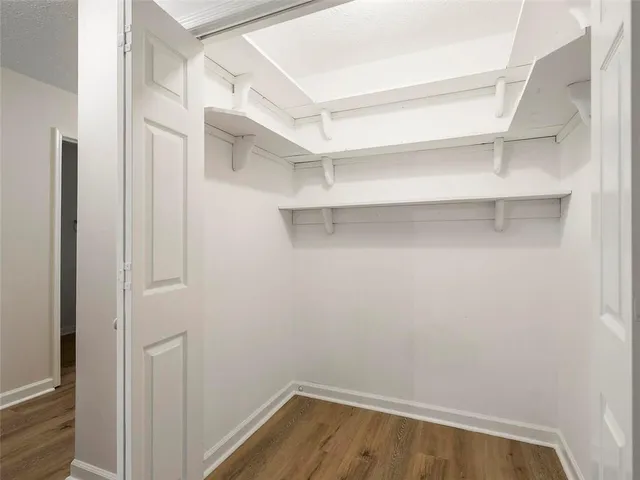a view of walk in closet with empty racks