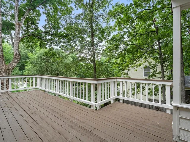 a view of balcony with wooden floor and fence