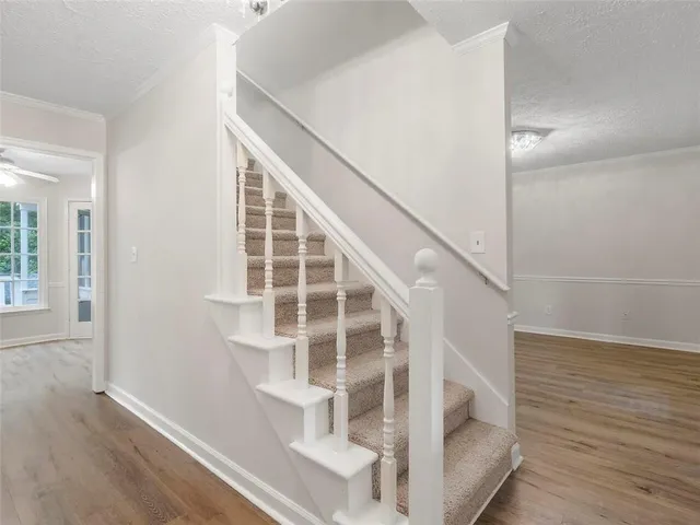 a view of entryway and hall with wooden floor