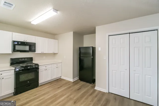a kitchen with stainless steel appliances granite countertop a refrigerator stove and sink