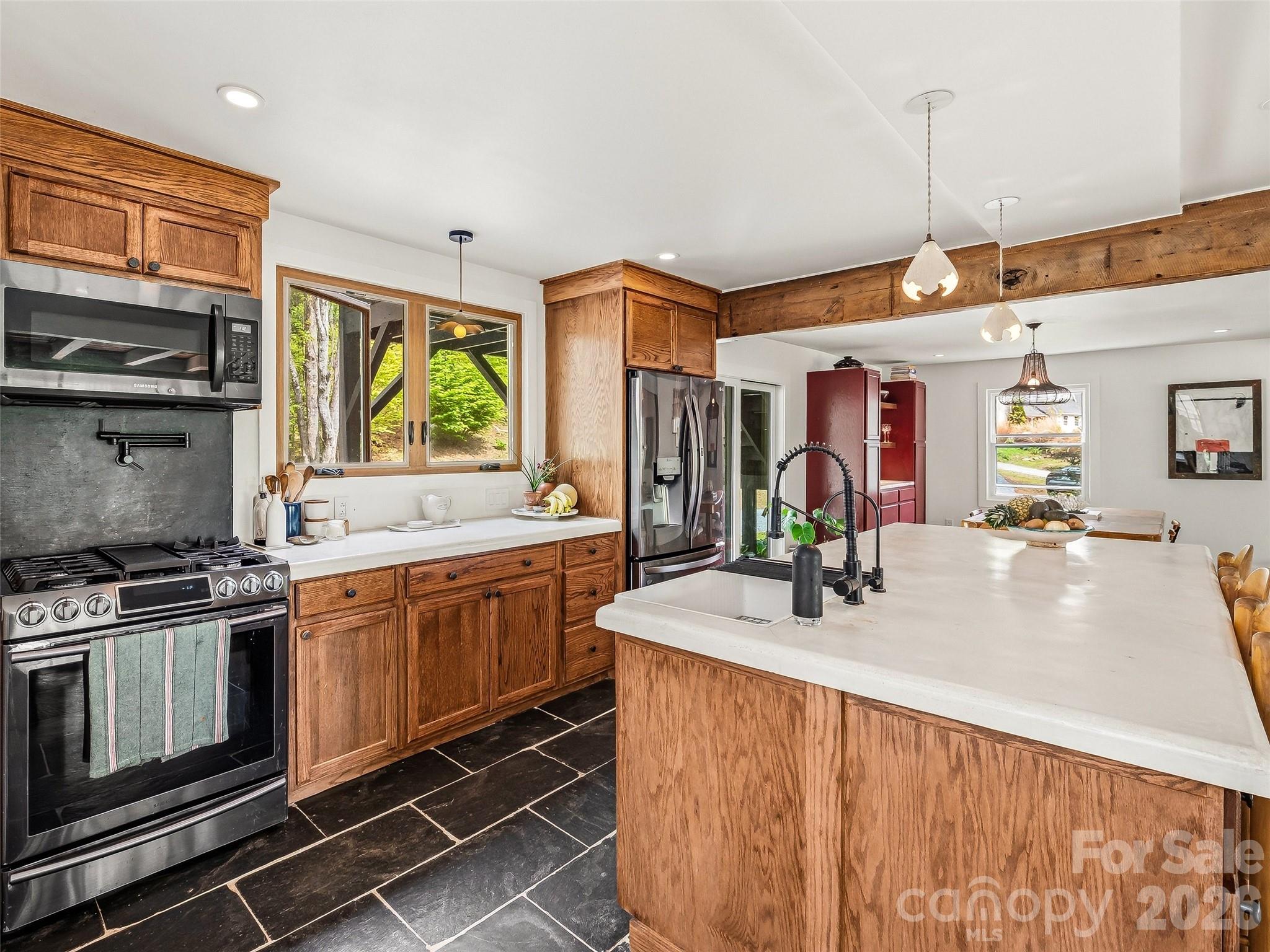 51 Mark Twain Road Asheville, NC 28805 - Photo 15 of 46 a kitchen with stainless steel appliances granite countertop a sink and stove
