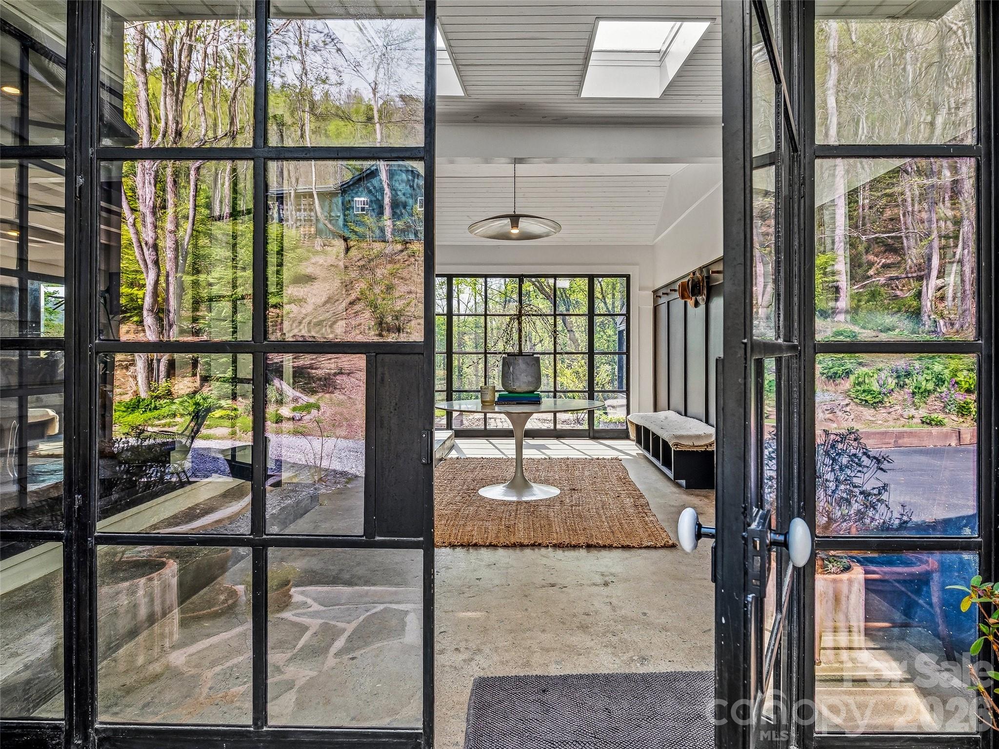 51 Mark Twain Road Asheville, NC 28805 - Photo 23 of 46 a living room with a floor to ceiling window and wooden floor