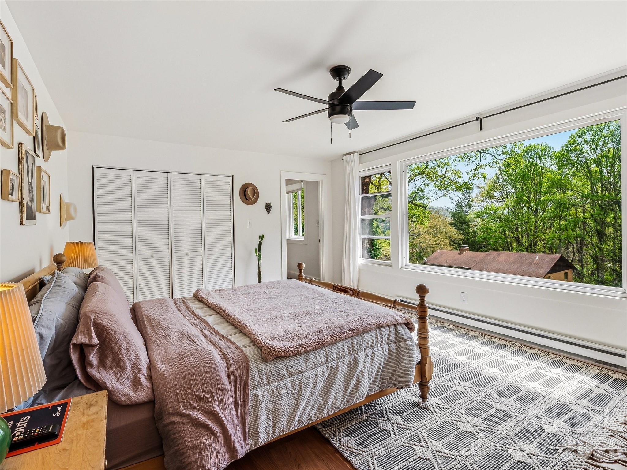 51 Mark Twain Road Asheville, NC 28805 - Photo 28 of 46 a bedroom with a bed and wooden floor