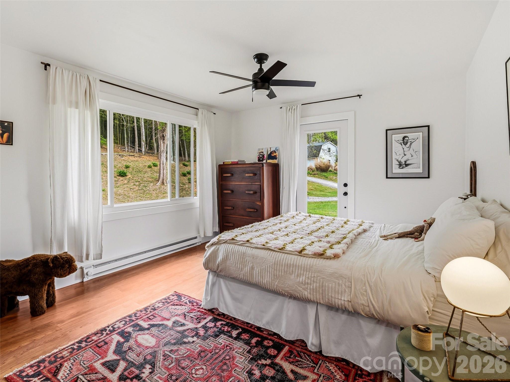 51 Mark Twain Road Asheville, NC 28805 - Photo 33 of 46 a bedroom with a bed and a dresser next to a window