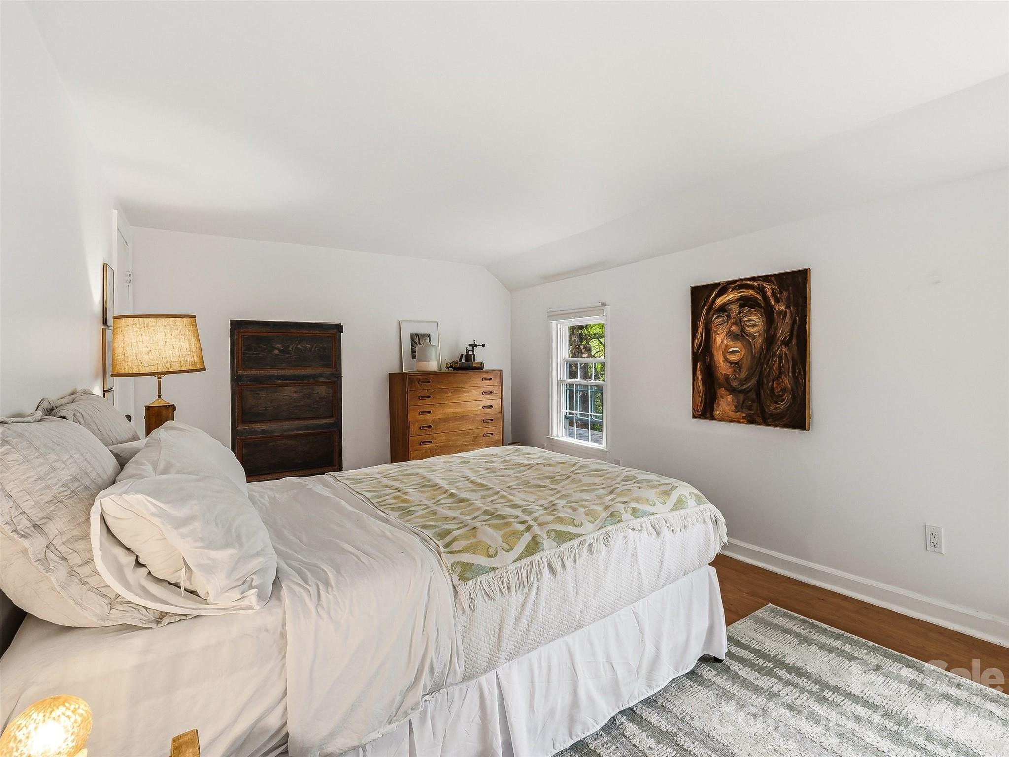 51 Mark Twain Road Asheville, NC 28805 - Photo 35 of 46 a bedroom with a bed and wooden floor
