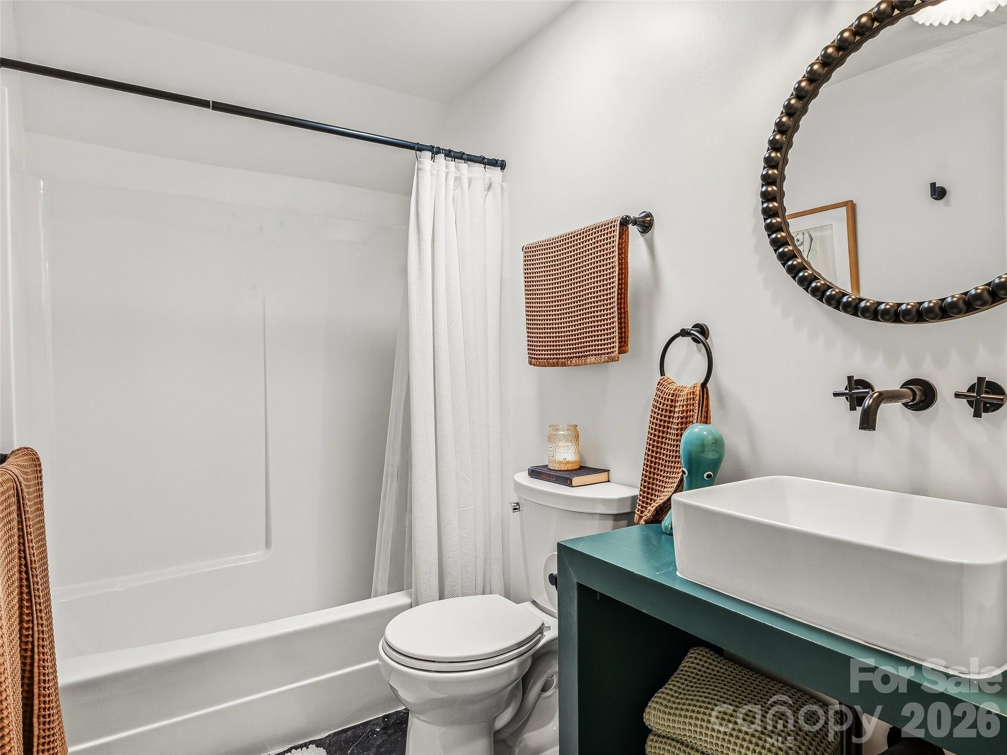 51 Mark Twain Road Asheville, NC 28805 - Photo 37 of 46 a bathroom with a sink a toilet and a mirror
