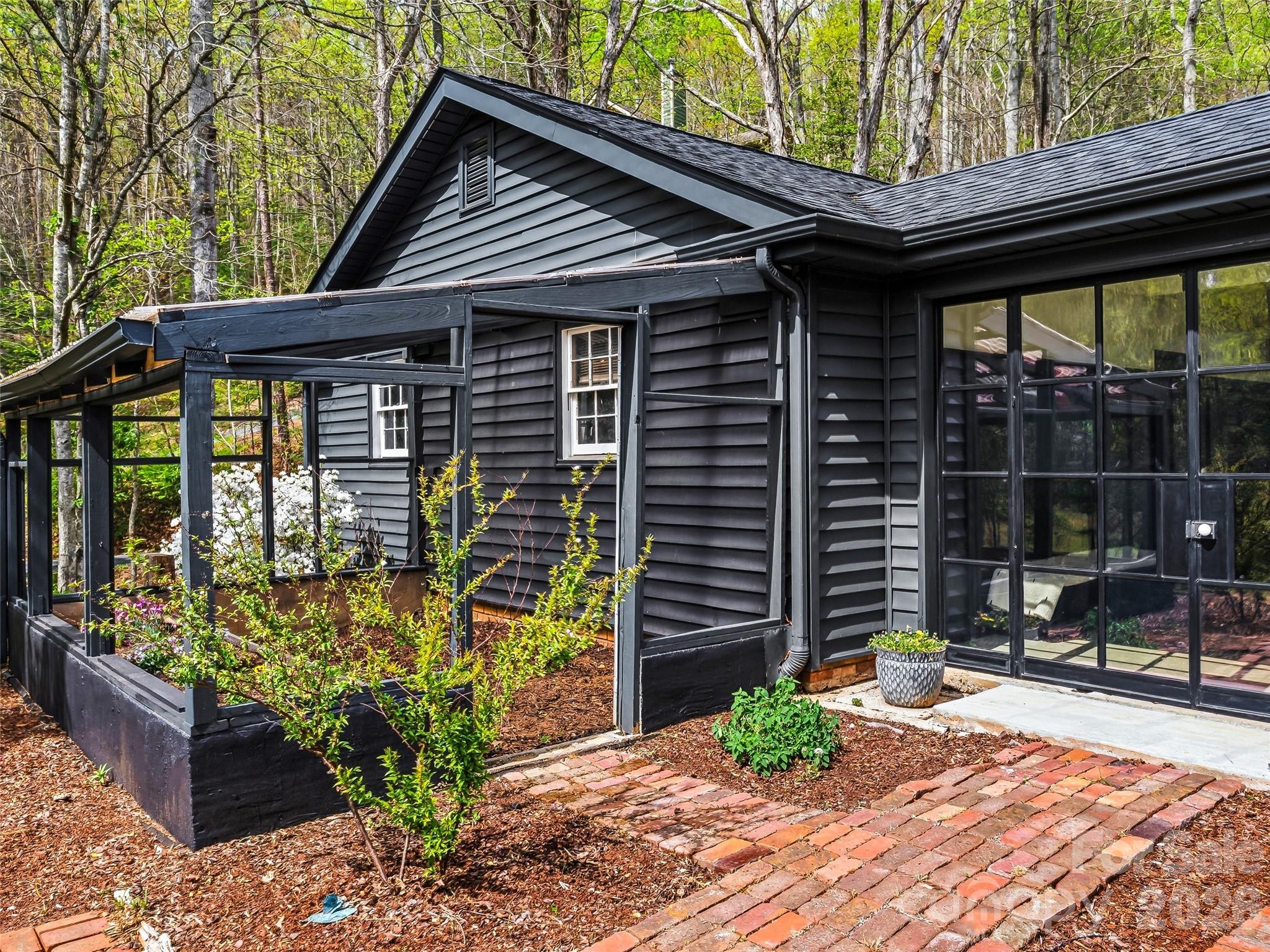 51 Mark Twain Road Asheville, NC 28805 - Photo 39 of 46 a front view of a house with garden