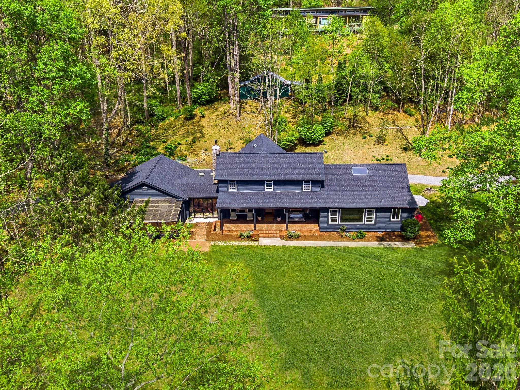 51 Mark Twain Road Asheville, NC 28805 - Photo 4 of 46 a view of a house with a big yard plants and large trees