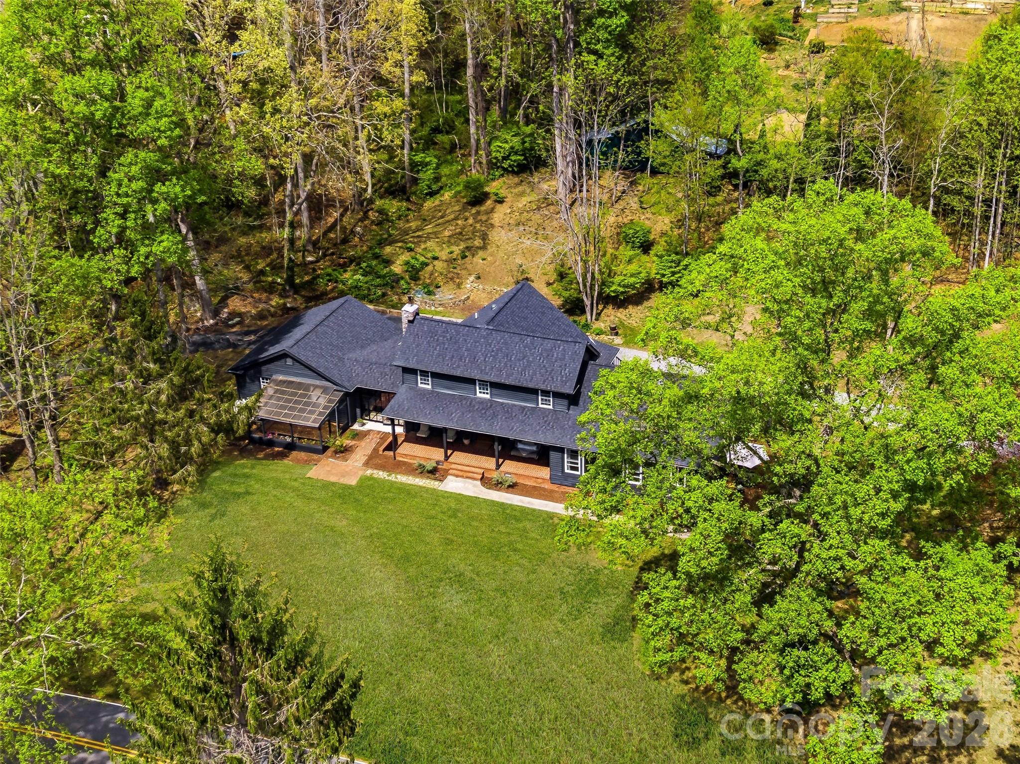 51 Mark Twain Road Asheville, NC 28805 - Photo 45 of 46 an aerial view of a house with swimming pool and garden