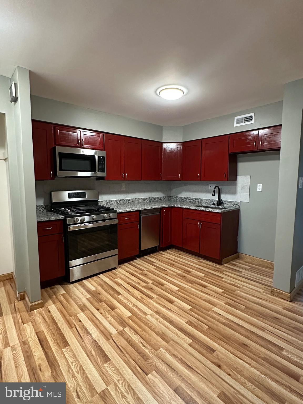 12077 Abby Road Philadelphia, PA 19154 - Photo 16 of 27 a kitchen with stainless steel appliances granite countertop a stove and a sink